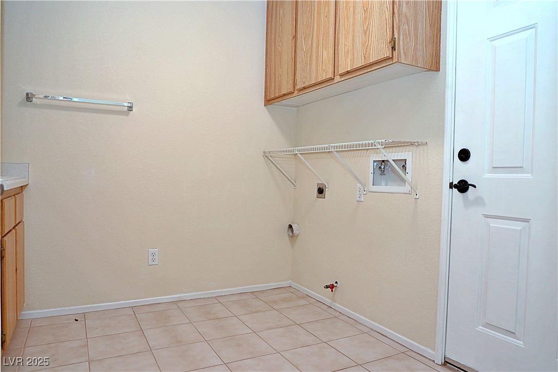 3349 Partridge Run Street Laughlin, NV 89029 - Photo 44 of 58 Laundry room featuring gas dryer hookup, cabinet space, hookup for a washing machine, light tile patterned floors, and hookup for an electric dryer