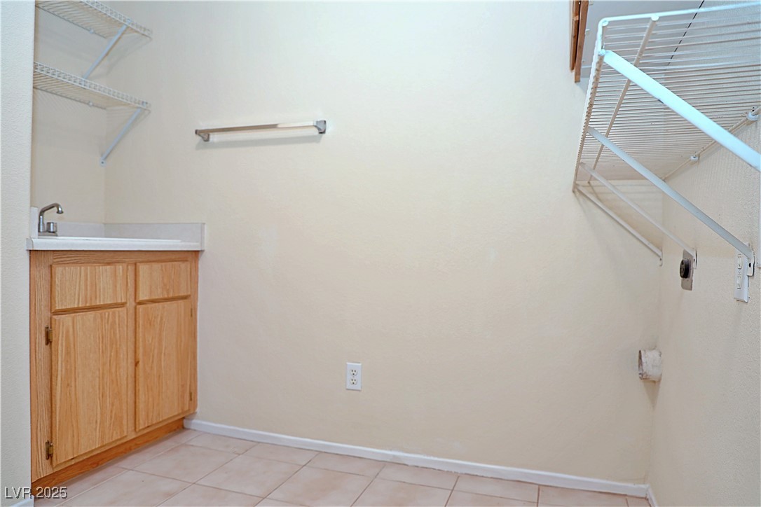 3349 Partridge Run Street Laughlin, NV 89029 - Photo 45 of 58 Laundry area with light tile patterned floors and electric dryer hookup
