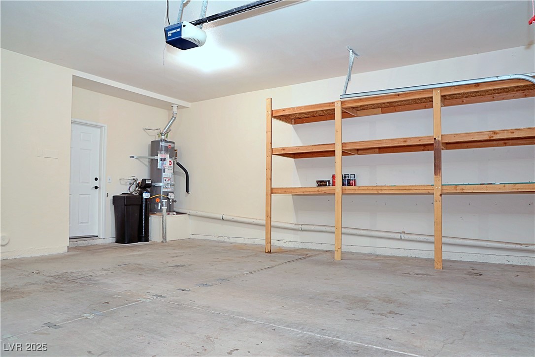 3349 Partridge Run Street Laughlin, NV 89029 - Photo 49 of 58 Garage featuring strapped water heater and a garage door opener