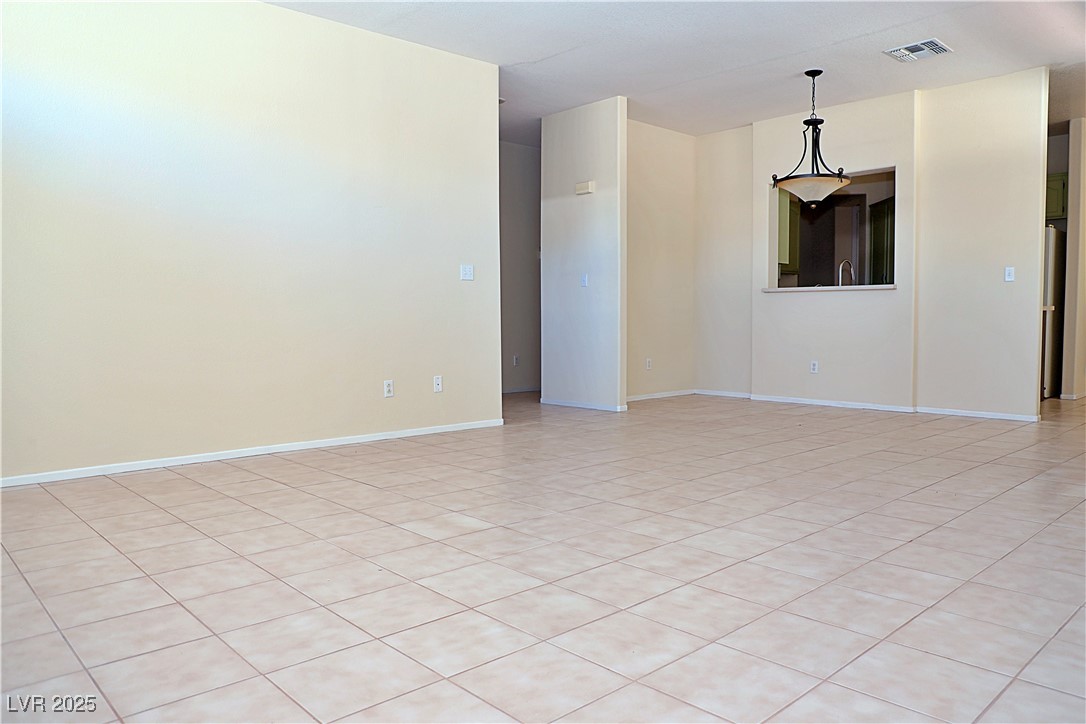 3349 Partridge Run Street Laughlin, NV 89029 - Photo 8 of 58 Empty room with light tile patterned floors and baseboards