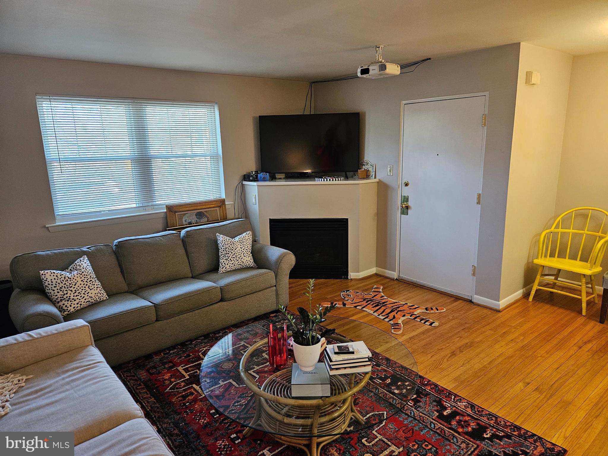 200 North Wayne Avenue, Unit 9 Wayne, PA 19087 - Photo 2 of 10 a living room with furniture a flat screen tv and a fireplace