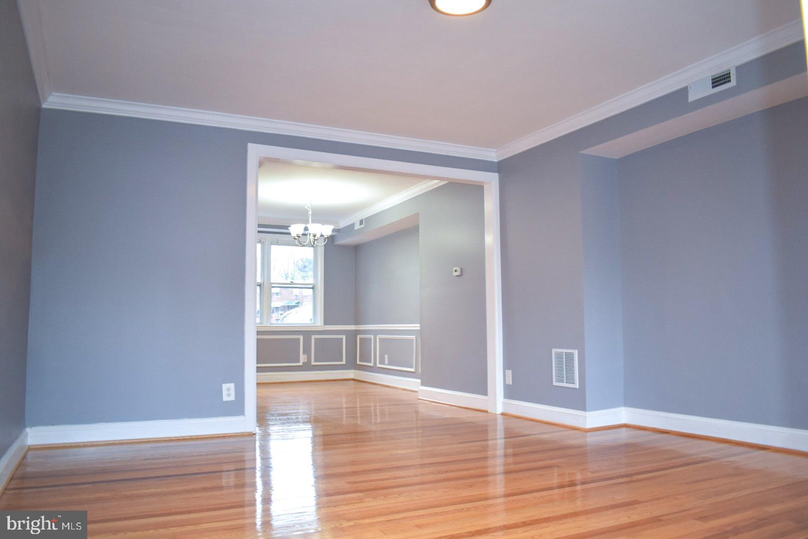 4227 Flowerton Road Baltimore, MD 21229 - Photo 2 of 45 a view of empty room with wooden floor and fan
