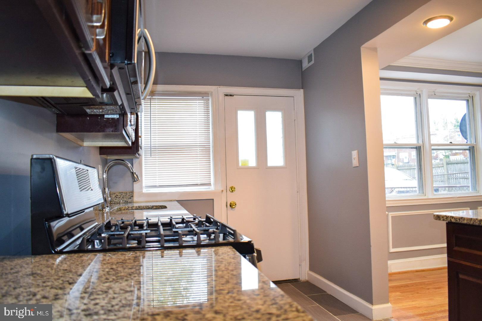 4227 Flowerton Road Baltimore, MD 21229 - Photo 13 of 45 a kitchen with stainless steel appliances granite countertop a sink stove and cabinets