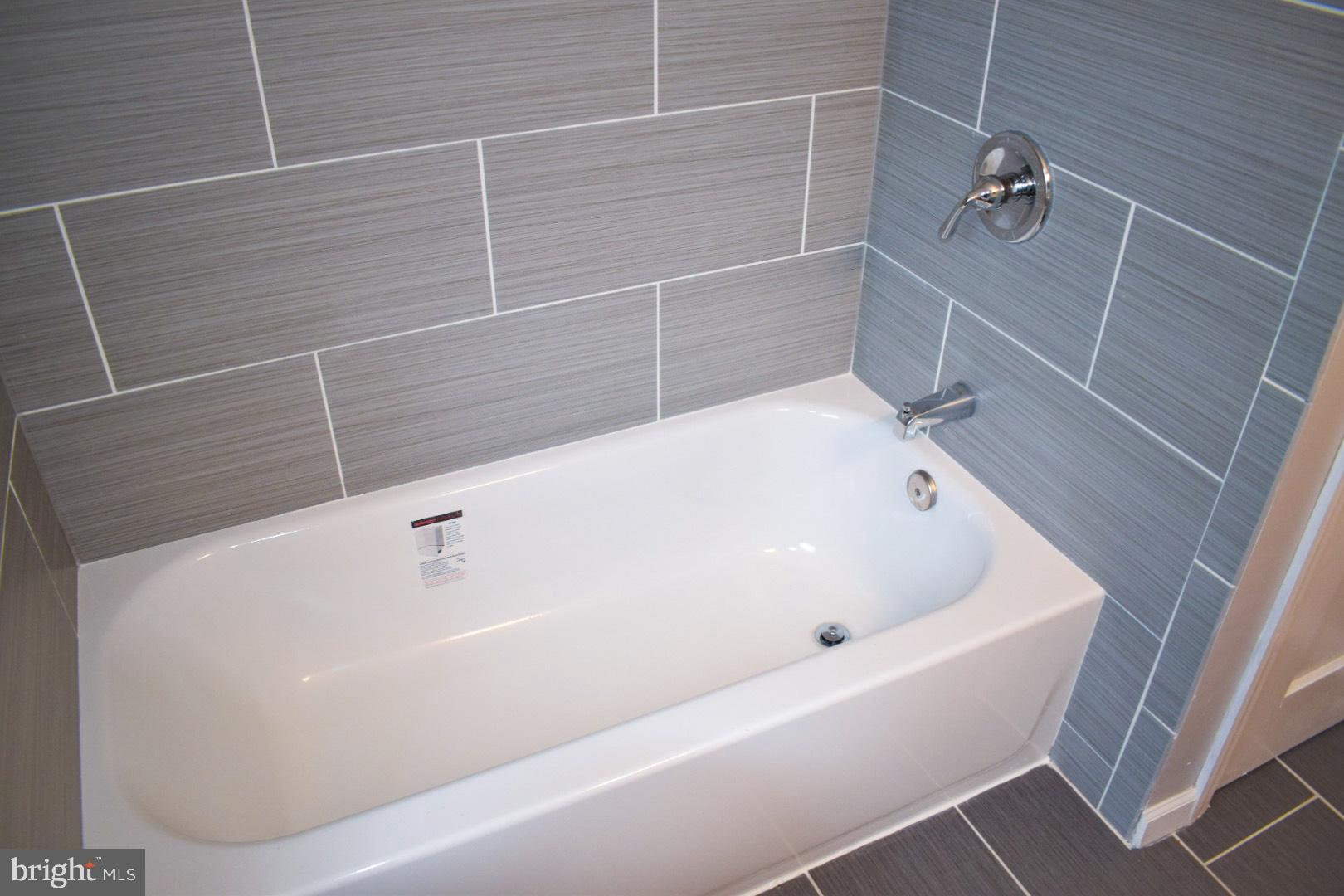 4227 Flowerton Road Baltimore, MD 21229 - Photo 20 of 45 a bathroom with a white bath tub
