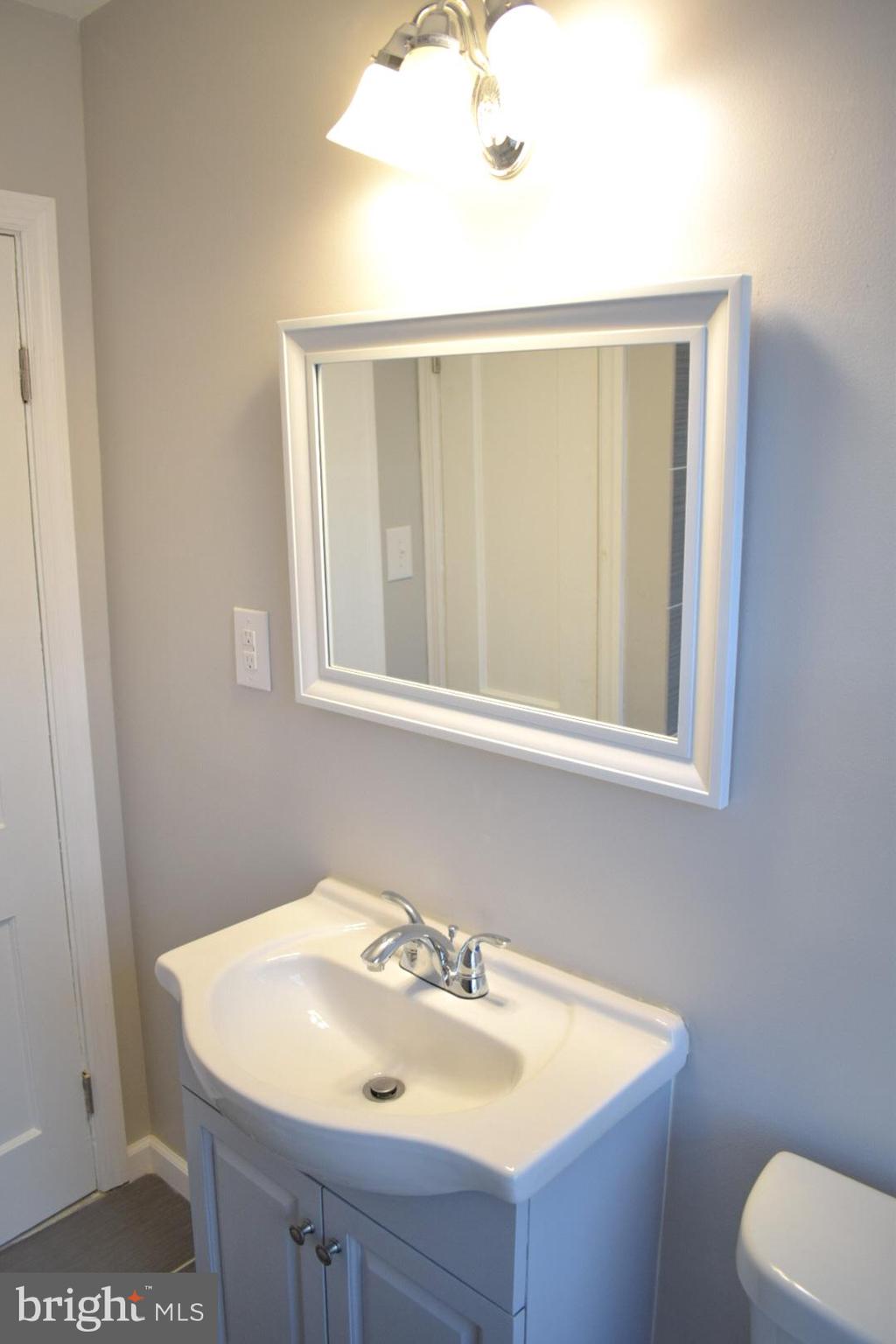 4227 Flowerton Road Baltimore, MD 21229 - Photo 22 of 45 a bathroom with a sink and a mirror