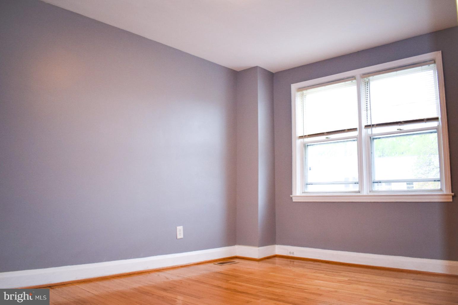 4227 Flowerton Road Baltimore, MD 21229 - Photo 25 of 45 an empty room with wooden floor and windows