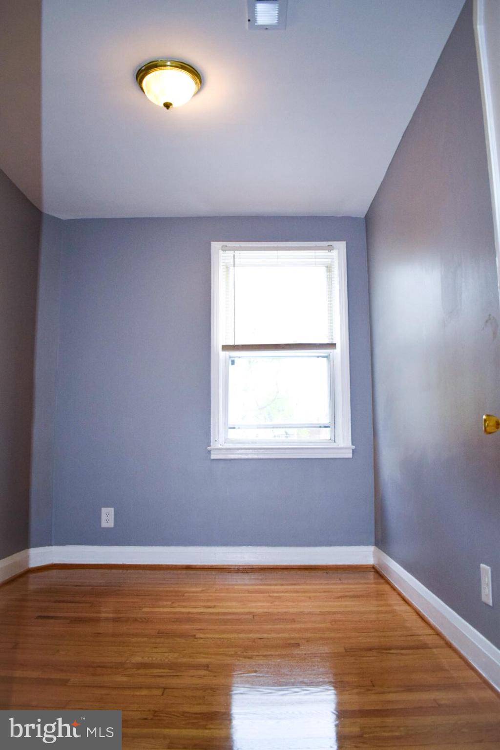 4227 Flowerton Road Baltimore, MD 21229 - Photo 30 of 45 an empty room with wooden floor and windows