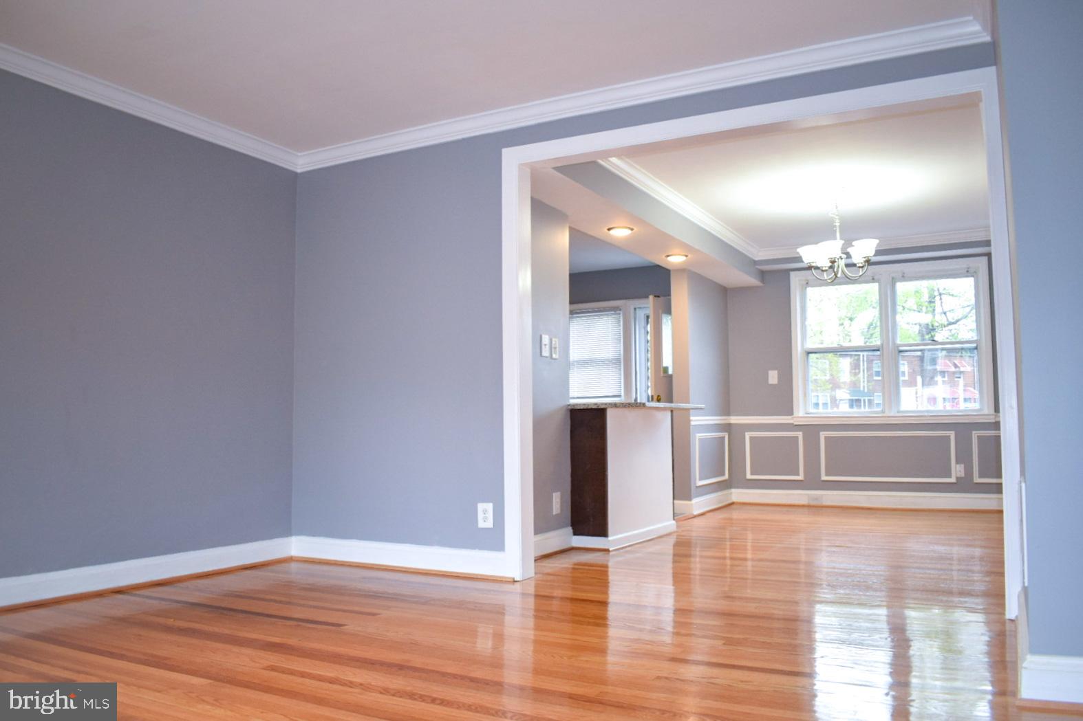 4227 Flowerton Road Baltimore, MD 21229 - Photo 4 of 45 a view of an empty room with window and wooden floor