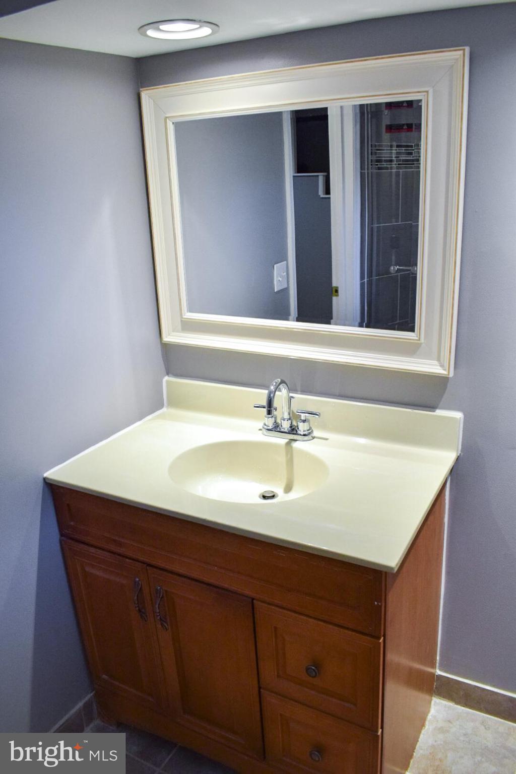 4227 Flowerton Road Baltimore, MD 21229 - Photo 32 of 45 a bathroom with a sink vanity and mirror