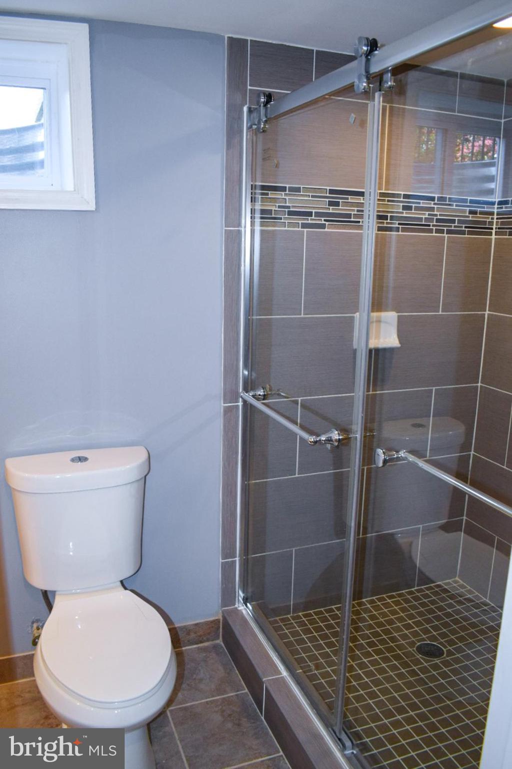 4227 Flowerton Road Baltimore, MD 21229 - Photo 33 of 45 a bathroom with a toilet and a shower