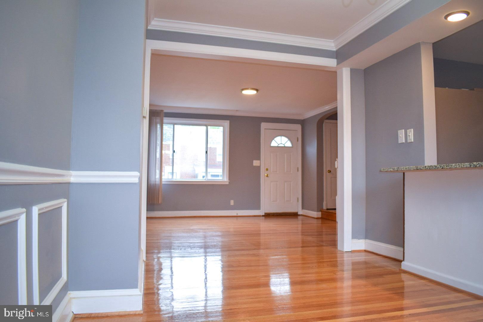 4227 Flowerton Road Baltimore, MD 21229 - Photo 5 of 45 a view of an empty room with wooden floor and a window