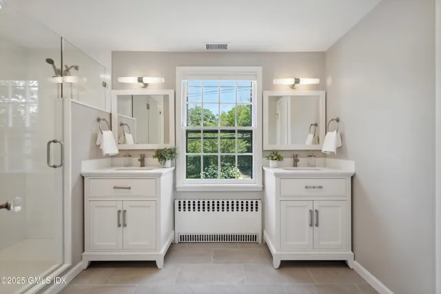 a bathroom with a balcony a sink tub and a window