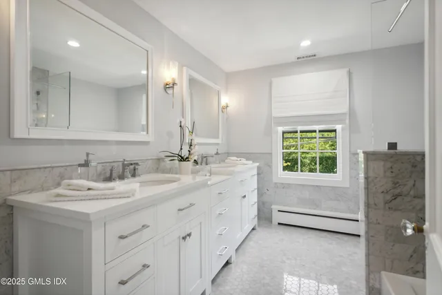 a bathroom with a granite countertop sink mirror and double