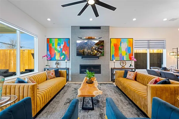 a living room with furniture fireplace and flat screen tv