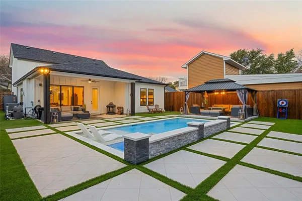 a view of a house with swimming pool and a yard