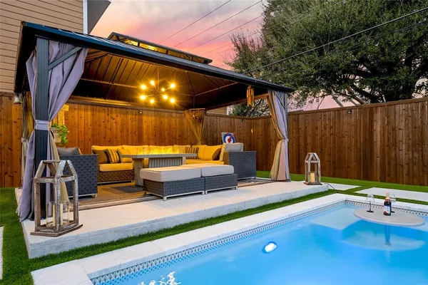 a backyard of a house with table and chairs