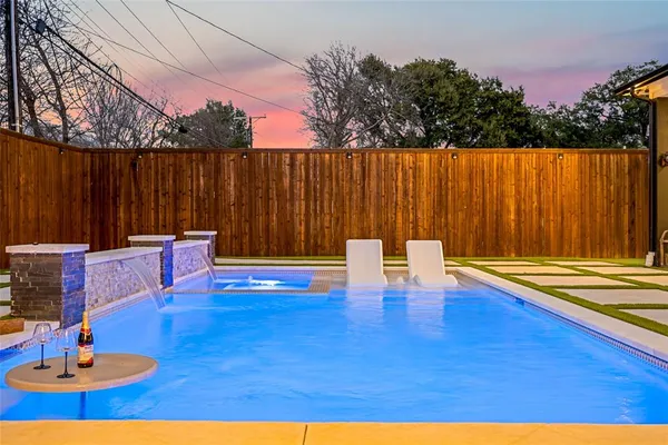 a backyard of a house with table and chairs