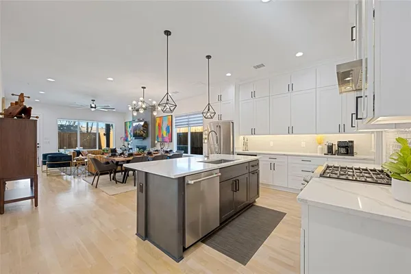 a kitchen that has a lot of cabinets in it and appliances