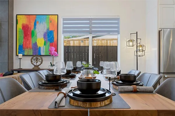 a living room with furniture and a painting on the wall