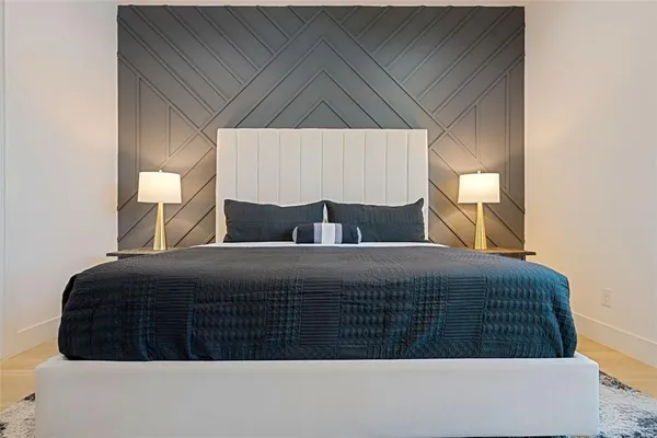 a bedroom with a bed and a night stand