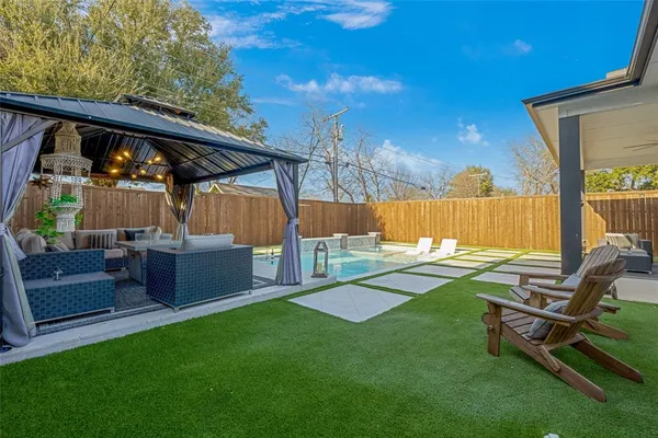 a view of a backyard with sitting area