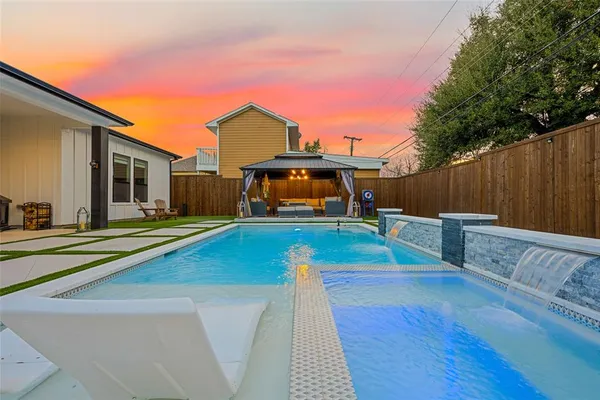 a view of a house with swimming pool with a yard
