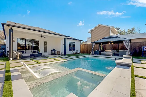 a view of a house with swimming pool and sitting area