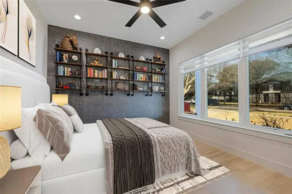a bedroom with a large bed and a large window