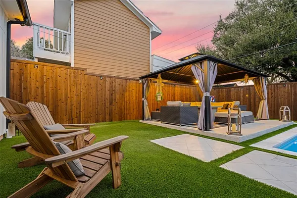 a view of backyard with a patio and outdoor seating