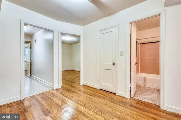 a view of a room with wooden floor