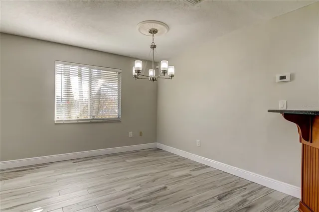 a view of a room with wooden floor and windows