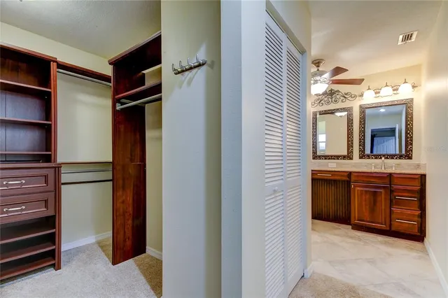 a view of walk in closet and bedroom