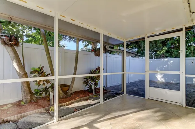 a view of a hallway with wooden floor and glass door