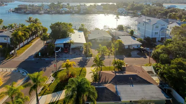 an aerial view of residential houses with outdoor space and lake view