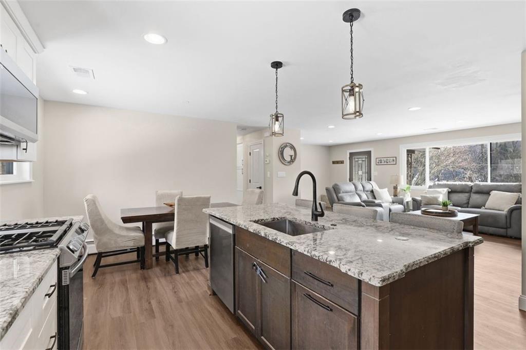 161 Harmony Road Wexford, PA 15090 - Photo 11 of 34 a kitchen with center island a sink appliances and a wooden floor