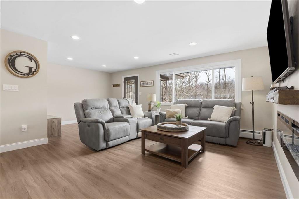 161 Harmony Road Wexford, PA 15090 - Photo 3 of 34 a living room with furniture a fireplace and a flat screen tv