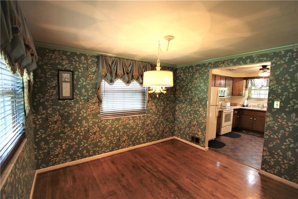 226 Waynesburg Road Washington, PA 15301 - Photo 4 of 24 Gorgeous Wood Floors in 11x10 Separate Formal Dining Room w/ Lamp Shade Style Chandelier & 2 Windows Allowing Natural Light to Flow through Nicely. Wide Opening into Kitchen and then straight into Sun Room offering a Convenient Floor Plan