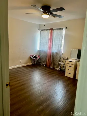 a view of a room with wooden floor and furniture