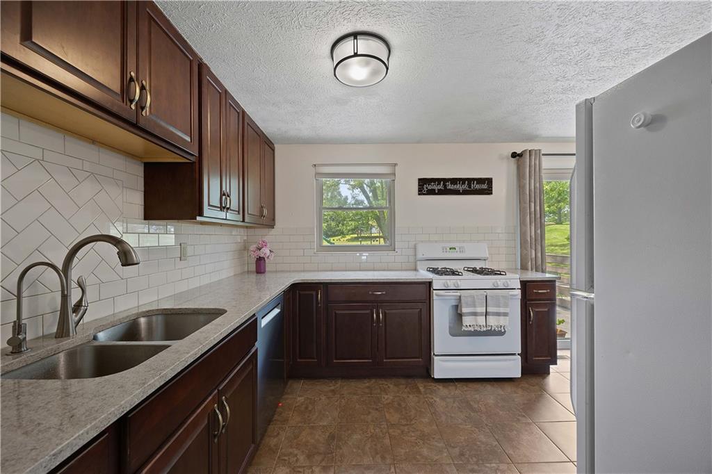 119 Summit Ridge Drive Bridgeville, PA 15017 - Photo 8 of 30 Updated kitchen includes new countertops, backsplash, cabinets, lighting, and flooring