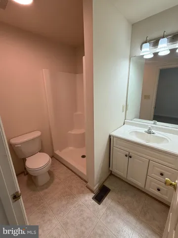 a bathroom with a toilet a sink and glass door