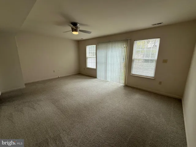 an empty room with a empty space and windows