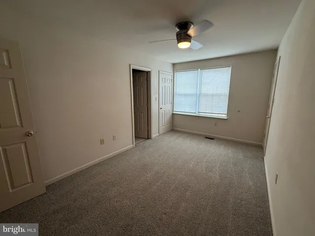 an empty room with a empty space and a window