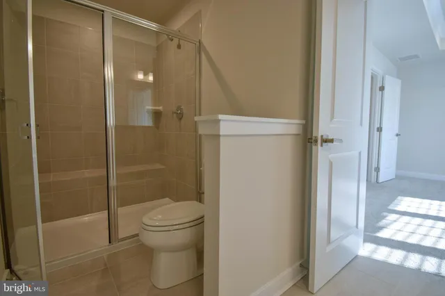 a bathroom with a shower and a toilet