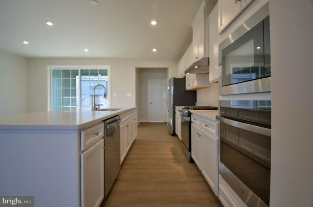 a kitchen with stainless steel appliances granite countertop a stove and a sink