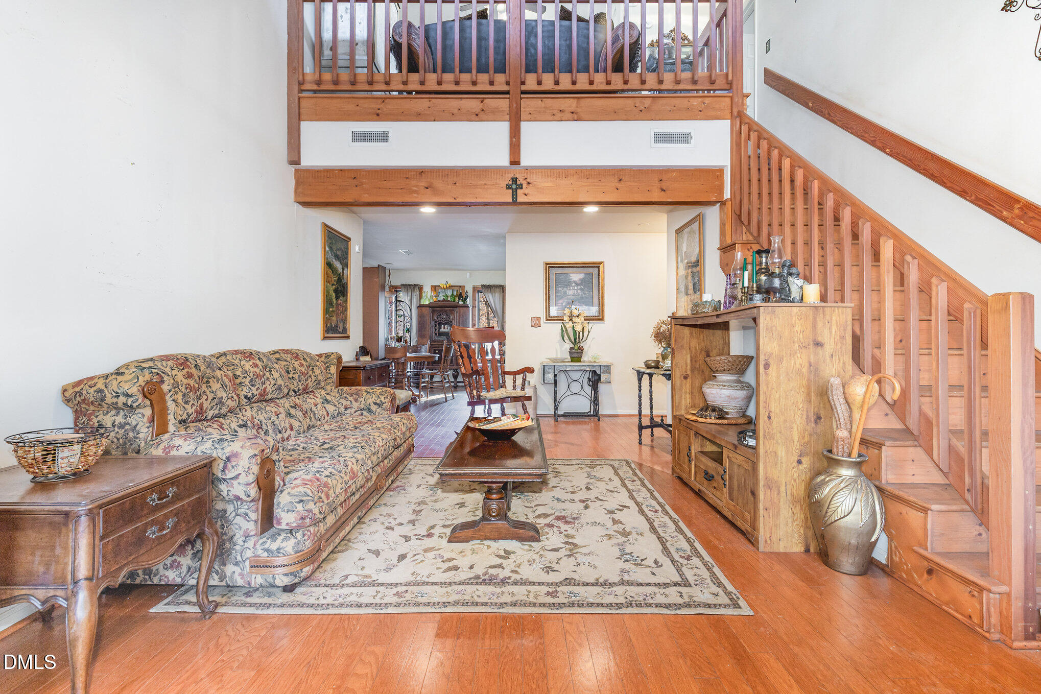 8516 Dunlee Falls Road Raleigh, NC 27613 - Photo 9 of 21 a living room with furniture and a chandelier