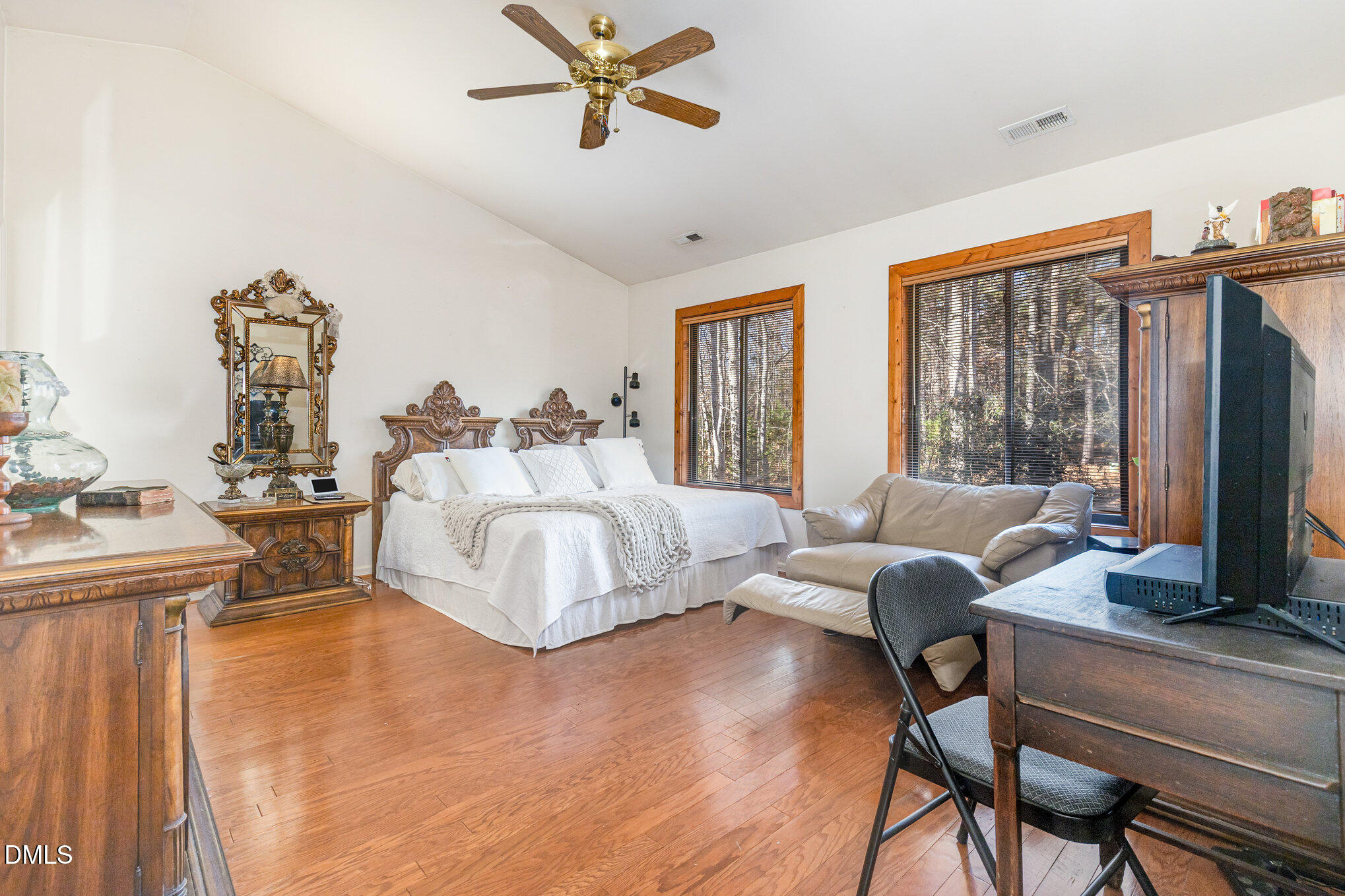8516 Dunlee Falls Road Raleigh, NC 27613 - Photo 16 of 21 a bedroom with a bed wooden floor and a large window