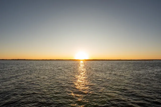 a lake view with lawn chairs