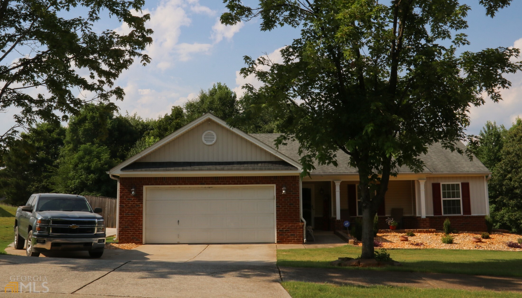 Front of House. Two Car Garage and Third Parking Pad