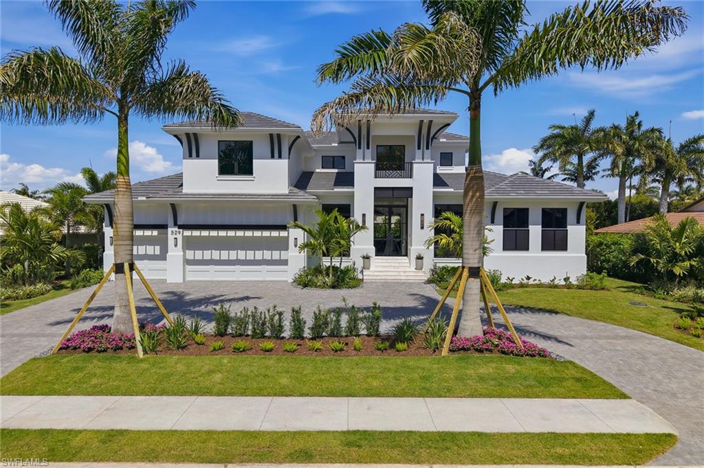 529 Neapolitan Way Naples, FL 34103 - Photo 26 of 26 a front view of a house with a yard