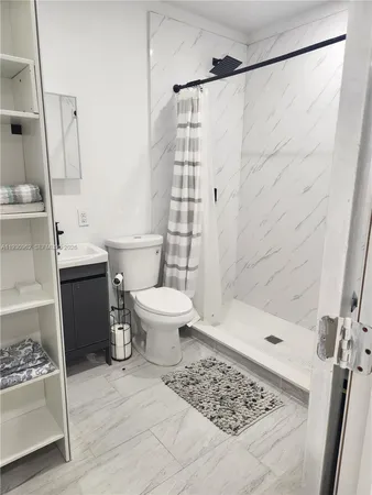 a bathroom with a sink toilet and shower